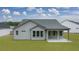 Rear view of a gray house with a covered patio and backyard at 3759 Tielman St, Snellville, GA 30078