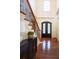 Bright entryway with hardwood floors, a staircase, and a black door at 3993 N Ivy Ne Rd, Atlanta, GA 30342