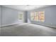 Spacious bedroom with large windows and plush carpeting at 1015 Nawench Dr, Atlanta, GA 30327