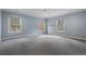 Spacious bedroom with soft blue walls, multiple windows, and plush carpeting at 1015 Nawench Dr, Atlanta, GA 30327