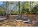 Stone water feature and partially fenced backyard with mature trees at 5955 Tibor Nw Dr, Acworth, GA 30101