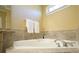 Bathroom with corner soaking tub and tile surround at 5955 Tibor Nw Dr, Acworth, GA 30101