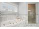 Bathroom features a jetted tub, walk-in shower, and marble tile at 5955 Tibor Nw Dr, Acworth, GA 30101