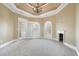 Bright bedroom with arched windows, fireplace, and access to balcony at 5955 Tibor Nw Dr, Acworth, GA 30101