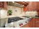 Stainless steel gas cooktop with custom cabinetry and granite countertops at 5955 Tibor Nw Dr, Acworth, GA 30101