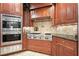 Modern kitchen with Wolf range, stainless steel appliances, and custom cabinetry at 5955 Tibor Nw Dr, Acworth, GA 30101