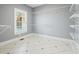 Laundry room with ample shelving and tile floor at 5955 Tibor Nw Dr, Acworth, GA 30101