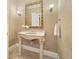 Elegant powder room with pedestal sink and ornate mirror at 5955 Tibor Nw Dr, Acworth, GA 30101