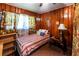 Bedroom with wood paneling and twin bed at 6055 Blackhawk Se Trl, Mableton, GA 30126