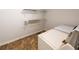Functional laundry room with washer, dryer, and overhead shelving at 6055 Blackhawk Se Trl, Mableton, GA 30126