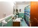 Small bathroom with teal tile and shower at 6055 Blackhawk Se Trl, Mableton, GA 30126
