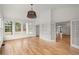 Bright sunroom with hardwood floors, multiple windows, and built-in shelving at 636 Ginger Cake Rd, Fayetteville, GA 30214