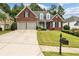 Brick house with two-car garage and manicured lawn at 143 Templeton Ln, Villa Rica, GA 30180