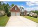 Brick home with a two car garage and well-kept lawn at 143 Templeton Ln, Villa Rica, GA 30180