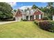Brick two-story house with gray accents, two-car garage, and landscaped lawn at 143 Templeton Ln, Villa Rica, GA 30180