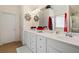 Bathroom with double vanity, large mirror, and a bathtub at 143 Templeton Ln, Villa Rica, GA 30180