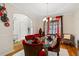 Formal dining room featuring a glass-top table and red velvet chairs at 143 Templeton Ln, Villa Rica, GA 30180