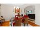 Elegant dining room with glass table, red chairs, and hardwood floors at 143 Templeton Ln, Villa Rica, GA 30180