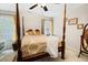 Main bedroom with a four-poster bed, ceiling fan and plenty of natural light at 143 Templeton Ln, Villa Rica, GA 30180