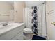 Clean bathroom with white vanity, shower/tub combo and floral shower curtain at 143 Templeton Ln, Villa Rica, GA 30180