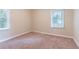 Spacious bedroom with neutral carpeting and two windows at 1788 Danrich Dr, Decatur, GA 30032