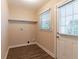 Bright laundry room with wood-look flooring and ample shelving at 1788 Danrich Dr, Decatur, GA 30032