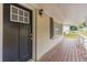 Covered porch with dark-colored door and wood flooring at 1788 Danrich Dr, Decatur, GA 30032