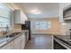 Renovated kitchen featuring granite countertops, stainless steel appliances, and white cabinets at 1788 Danrich Dr, Decatur, GA 30032