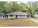 Brick ranch home with a covered porch and a well-manicured lawn at 1788 Danrich Dr, Decatur, GA 30032