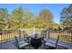 Deck with patio furniture and fire pit overlooking backyard at 176 Northmill Pkwy, Stockbridge, GA 30281