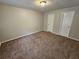 Bright bedroom with brown carpet and neutral walls at 199 Holly Springs Ct, Ellenwood, GA 30294