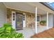 Inviting front porch with stone facade and welcoming seating area at 3413 Greystone Dr, Loganville, GA 30052