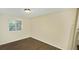 Simple bedroom with wood-look floors and a window at 5595 Marbut Rd, Lithonia, GA 30058