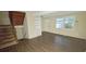 Living room with wood-look floors and view of staircase at 5595 Marbut Rd, Lithonia, GA 30058