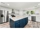 Open concept kitchen with island, stainless steel appliances, and wood-look flooring at 831 Mercury Nw Dr, Atlanta, GA 30331