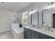 Modern bathroom with double vanity, soaking tub, and walk in shower at 1870 Mayfield Rd, Alpharetta, GA 30009