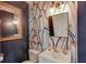 Stylish powder room with navy walls, banana leaf wallpaper, and gold accents at 1870 Mayfield Rd, Alpharetta, GA 30009