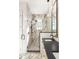 Elegant bathroom with a large walk-in shower and marble tile at 1184 Lupo Loop, Chattahoochee Hills, GA 30268