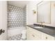 Clean bathroom with a shower/tub combo, patterned tile, and modern vanity at 1184 Lupo Loop, Chattahoochee Hills, GA 30268
