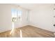 Light-filled bedroom with hardwood floors and expansive windows at 1184 Lupo Loop, Chattahoochee Hills, GA 30268