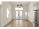 Bright dining room with hardwood floors and French doors leading to a patio at 1184 Lupo Loop, Chattahoochee Hills, GA 30268