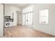 Bright kitchen with white cabinets, marble backsplash, and hardwood floors at 1184 Lupo Loop, Chattahoochee Hills, GA 30268
