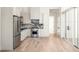 Modern kitchen with stainless steel appliances and light wood floors at 1184 Lupo Loop, Chattahoochee Hills, GA 30268