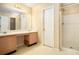 Bathroom with double vanity, shower, and neutral-toned finishes at 4103 Kingship Dr, Ellenwood, GA 30294