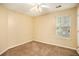 Bright bedroom with neutral walls, carpet flooring, and a window with blinds at 4103 Kingship Dr, Ellenwood, GA 30294