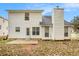 Rear view of a house with white siding, a patio, and a chimney at 4103 Kingship Dr, Ellenwood, GA 30294