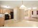 Kitchen features light wood cabinets, black appliances, and access to the dining area at 4103 Kingship Dr, Ellenwood, GA 30294