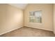 Well-lit bedroom featuring neutral walls, carpet flooring, and a window with blinds at 4103 Kingship Dr, Ellenwood, GA 30294