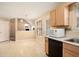 Eat-in kitchen with wood cabinets and access to the living room at 4103 Kingship Dr, Ellenwood, GA 30294