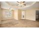 Spacious carpeted bedroom with ceiling fan and access to bathroom at 4103 Kingship Dr, Ellenwood, GA 30294